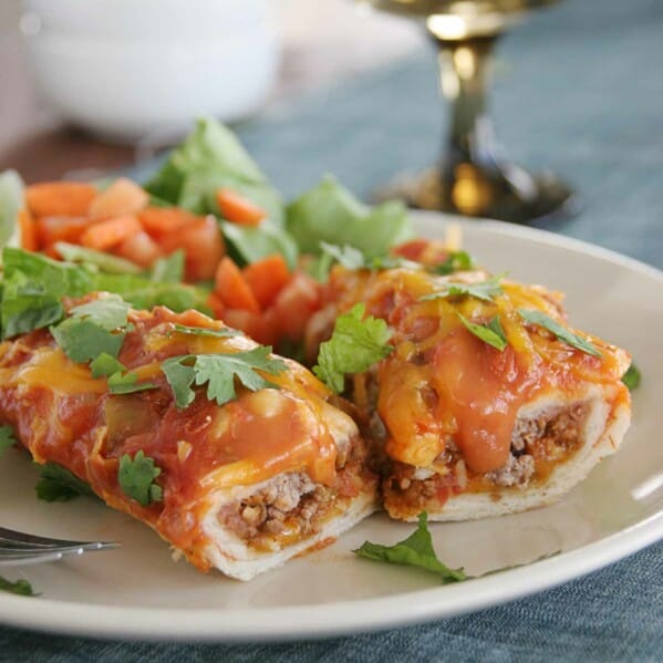 Cheddar Beef Enchiladas cut open on a plate