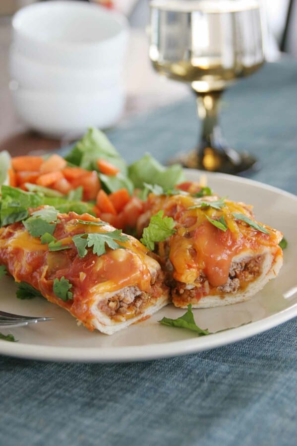 Cheddar Beef Enchiladas cut open on a plate
