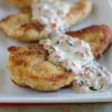 Chicken on a plate with basil cream sauce