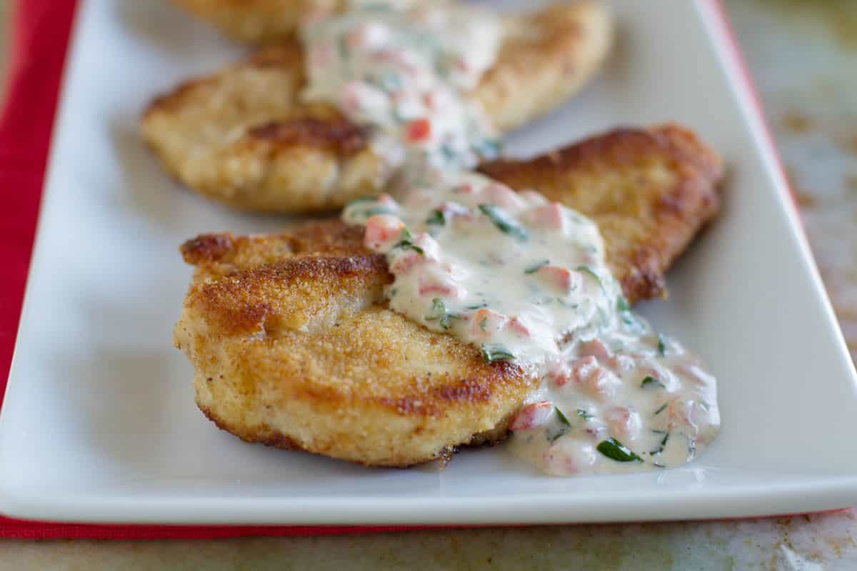 Chicken on a plate with basil cream sauce