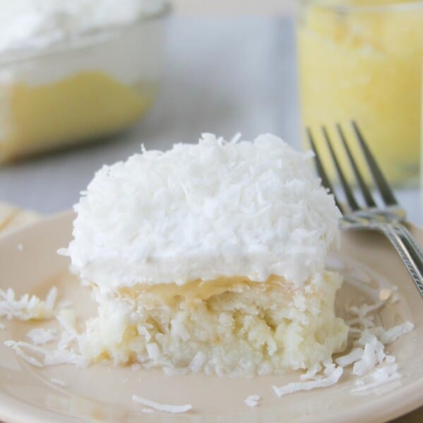 slice of lemon and coconut poke cake