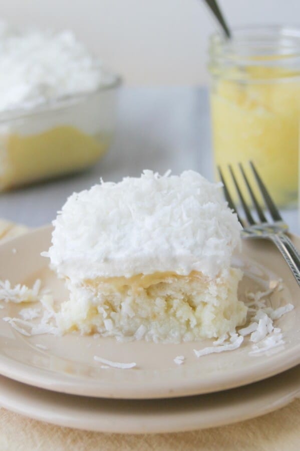 slice of lemon and coconut poke cake