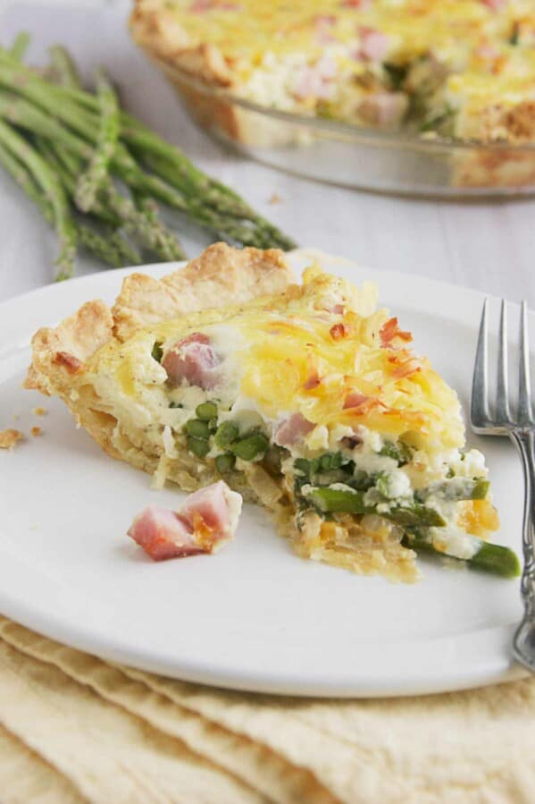 Slice of Ham Quiche with Asparagus.