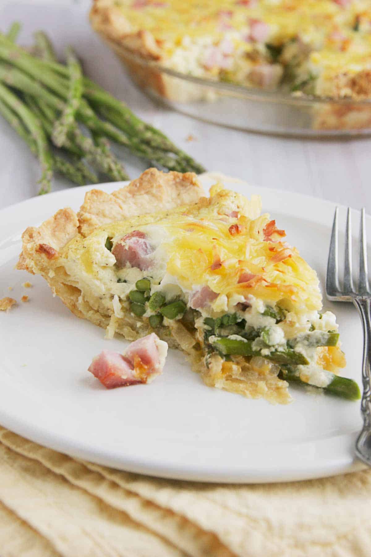 Slice of Ham Quiche with Asparagus.
