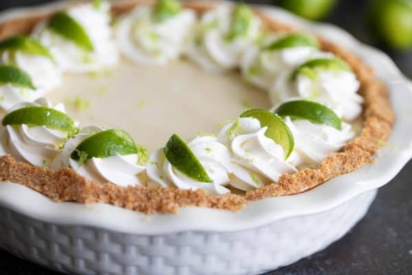 Key Lime Pie Topped with Whipped Cream and Limes