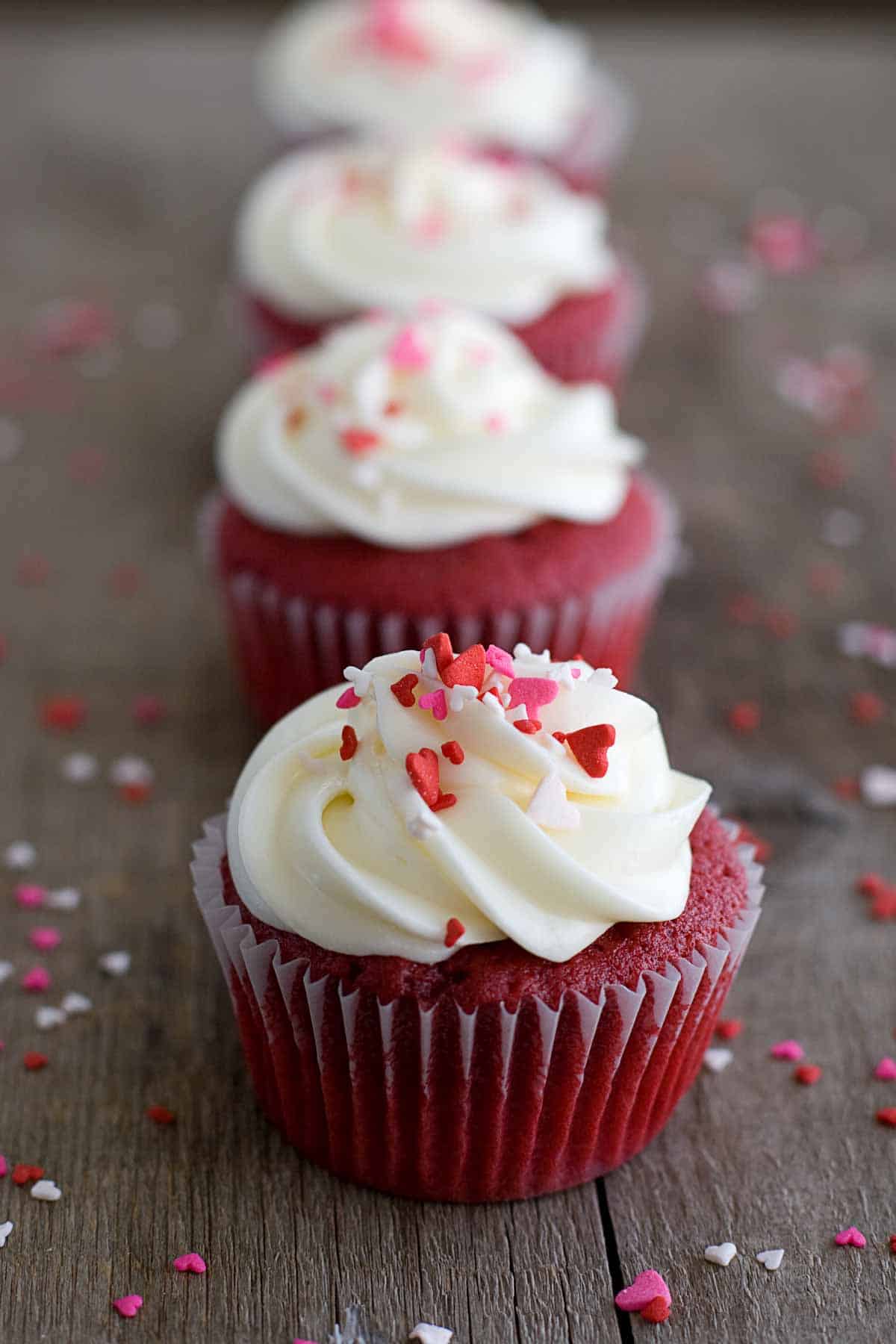 Red Velvet Cupcakes topped with frosting and sprinkles