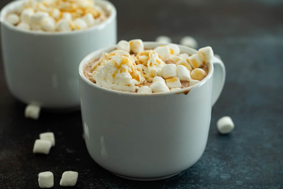 Mug of Salted Caramel Hot Chocolate Topped with Whipped Cream and Marshmallows