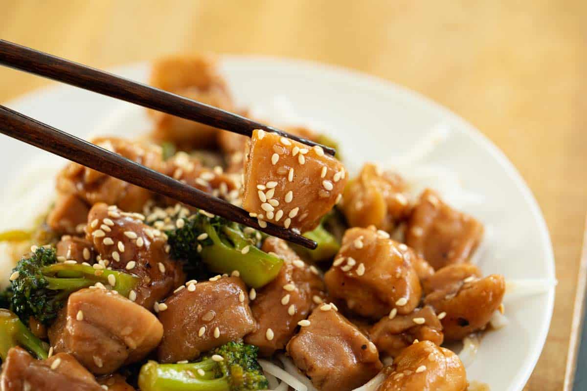 Bite of sesame chicken with chicken thighs