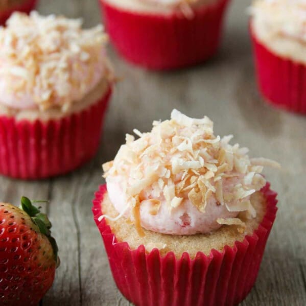 Strawberry, coconut and pineapple cupcakes topped with coconut frosting and toasted coconut