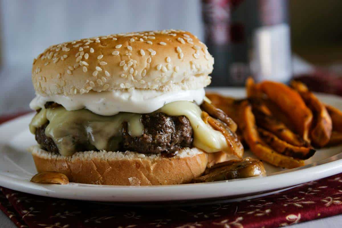 plate with Worcestershire Burger topped with cheese and sauce