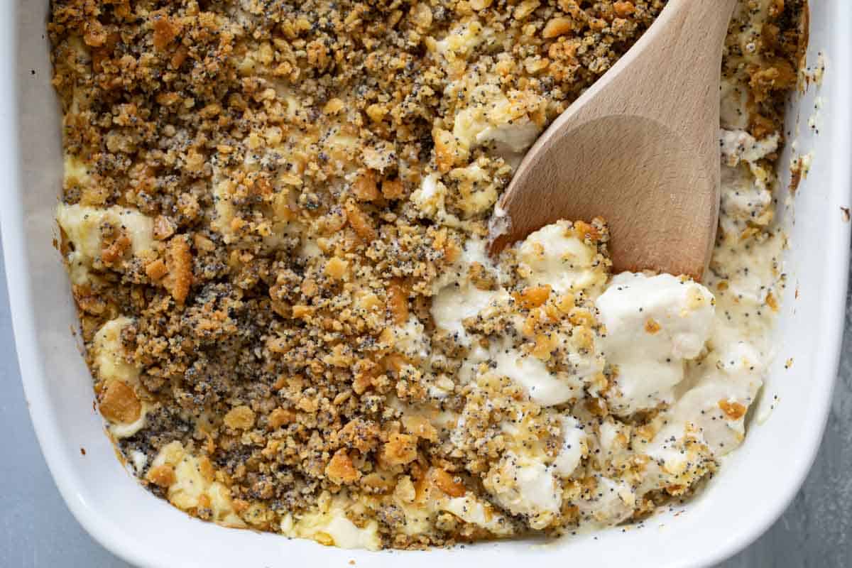 overhead view of Dish of Poppy Seed Chicken with wooden spoon