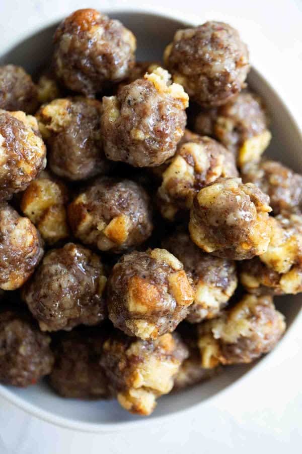 bowl of breakfast sausage meatballs with maple syrup