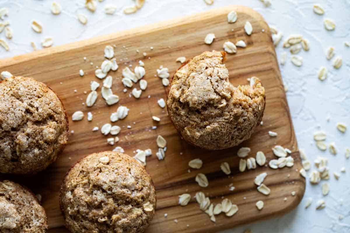 A healthy-ish breakfast recipe, these Oatmeal Muffins with Applesauce are filling and flavorful and perfect for breakfast on the go. tops of oatmeal muffins with oats sprinkled