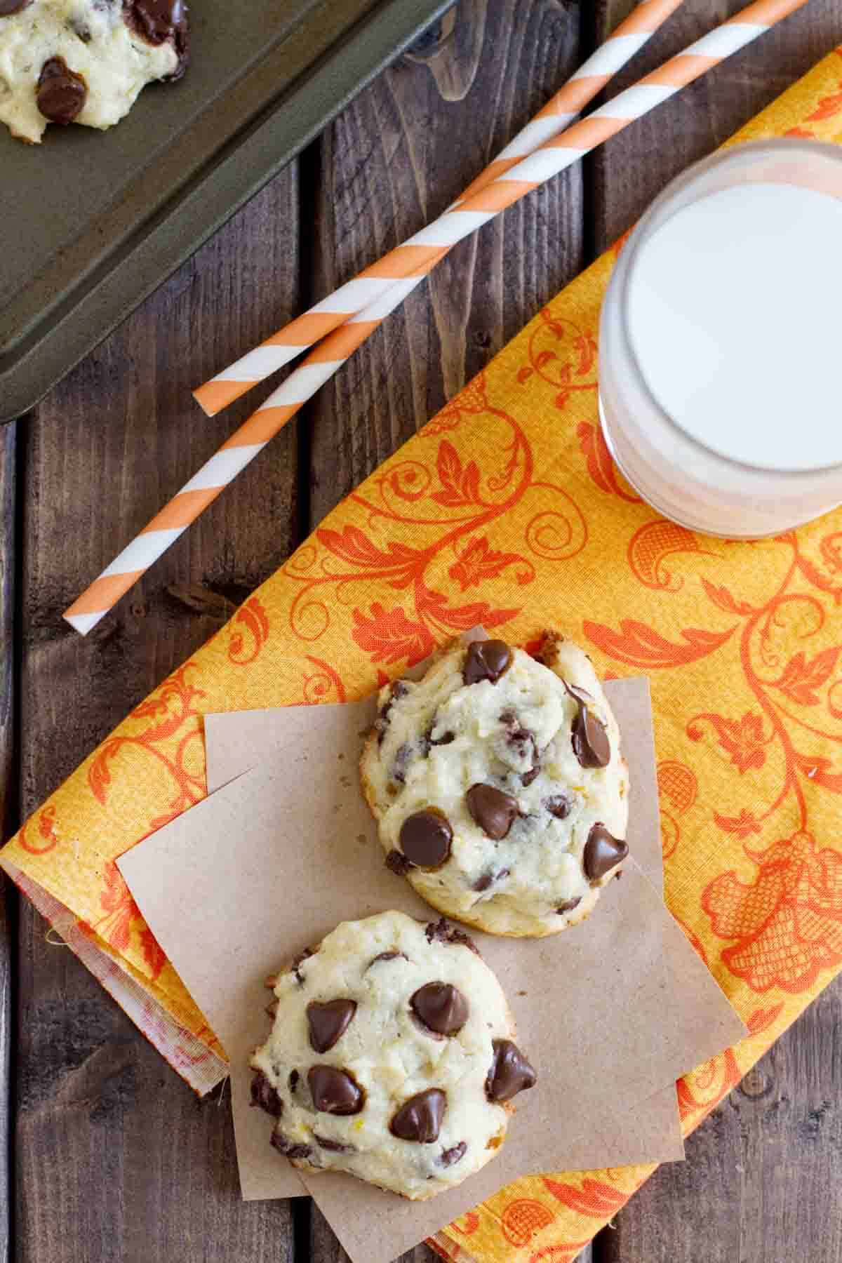 Two orange chocolate chip cookies with orange flavors on orange cloth