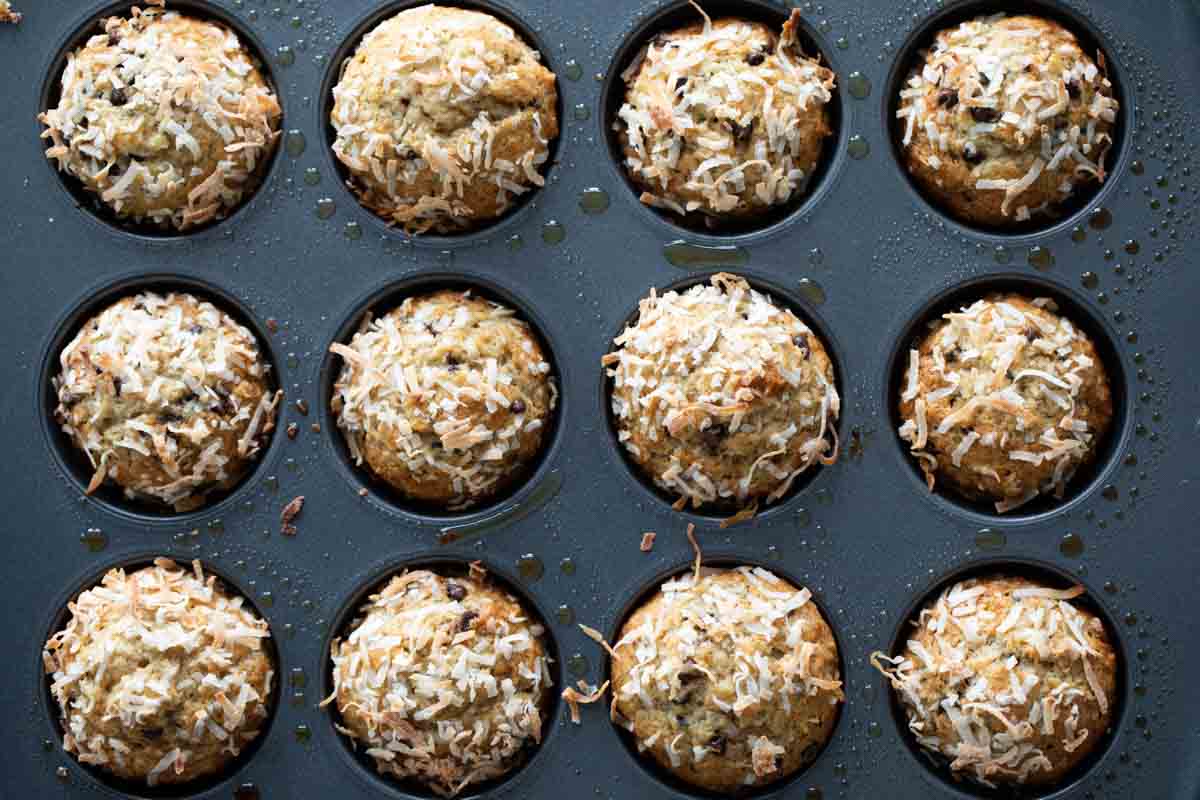 banana chocolate chip muffins in a muffin tin