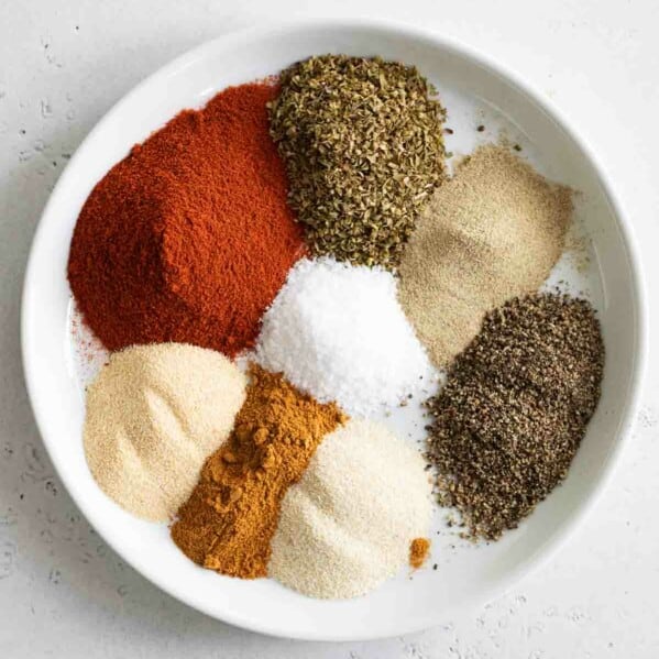 piles of spices needed to make homemade cajun seasoning
