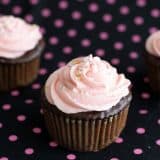 chocolate cupcakes topped with pink buttercream and sprinkles