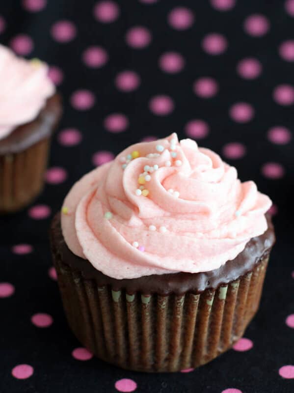 chocolate cupcakes topped with pink buttercream and sprinkles