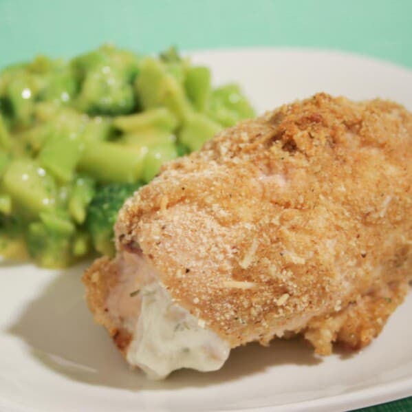 cheese stuffed chicken on a plate with broccoli