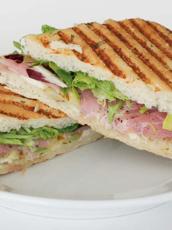 Grilled Eggplant, Prosciutto and Cheese Panini on a white plate