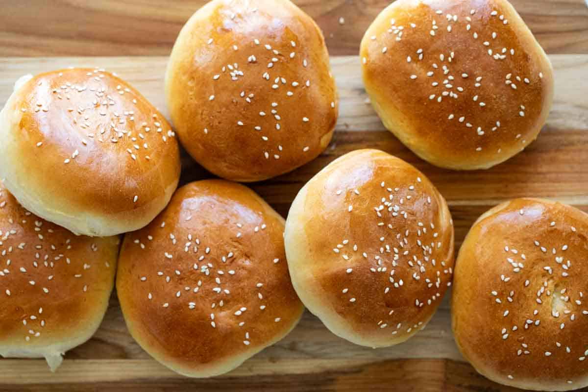 pile of hamburger buns on a cutting board