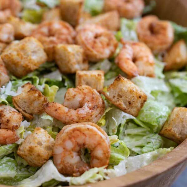 prepared Caesar salad with spicy shrimp and homemade croutons