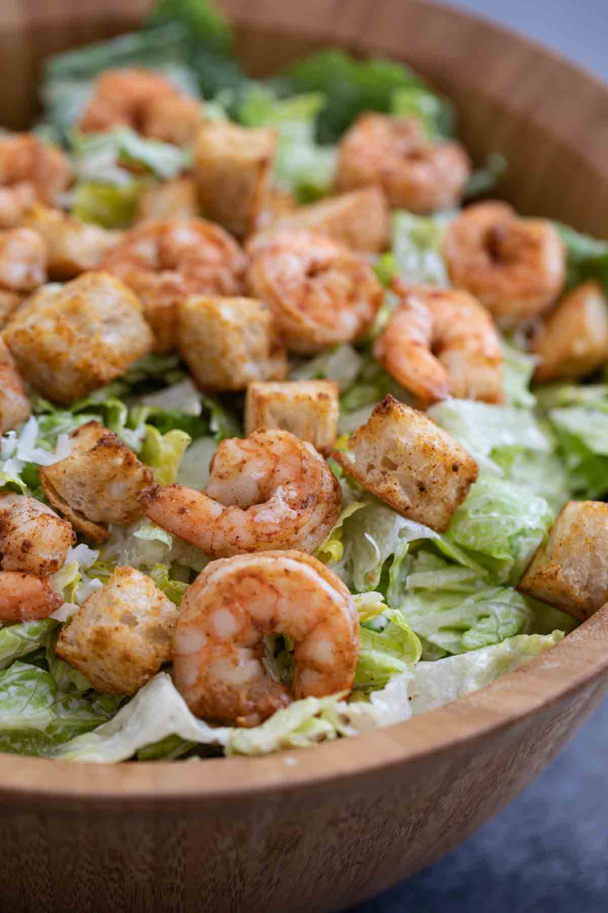 prepared Caesar salad with spicy shrimp and homemade croutons