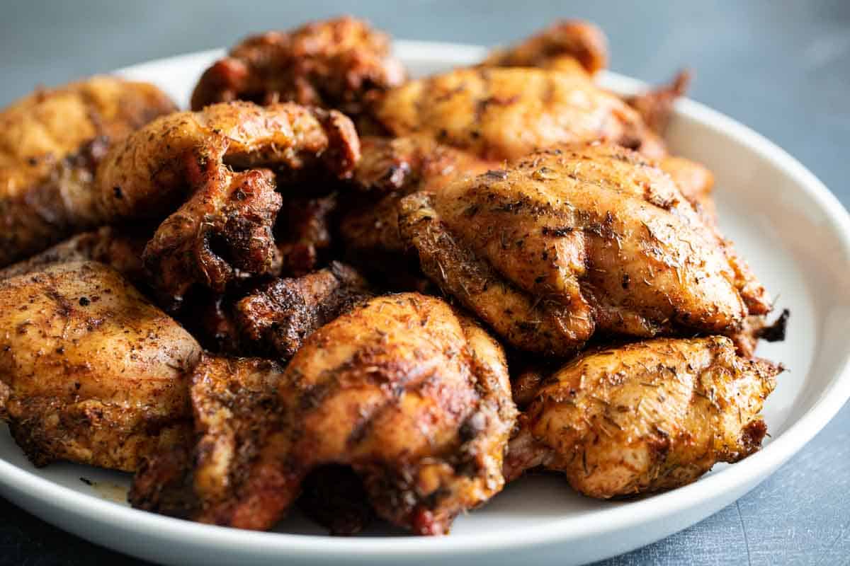 Easy and made from spices and herbs you probably already have on hand, this Grilled Chicken Seasoning turns boring chicken into something special. grilled chicken thighs on a white plate