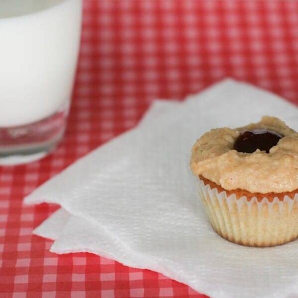Peanut Butter Cupcake topped with peanut butter frosting and jelly in the middle