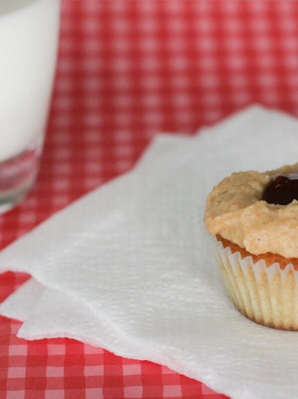 Peanut Butter Cupcake topped with peanut butter frosting and jelly in the middle