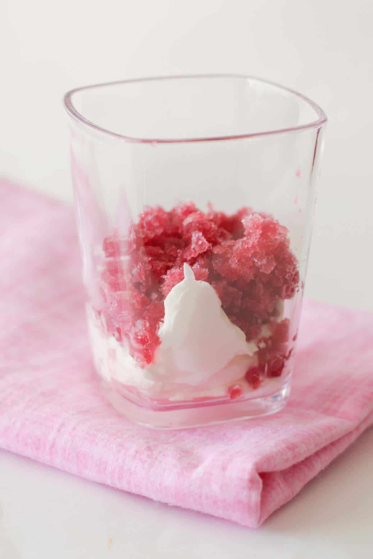 Pomegranate Granita with whipped cream in a cup