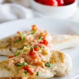 Chicken breasts topped with a cream sauce made with tomatoes, parmesan and basil