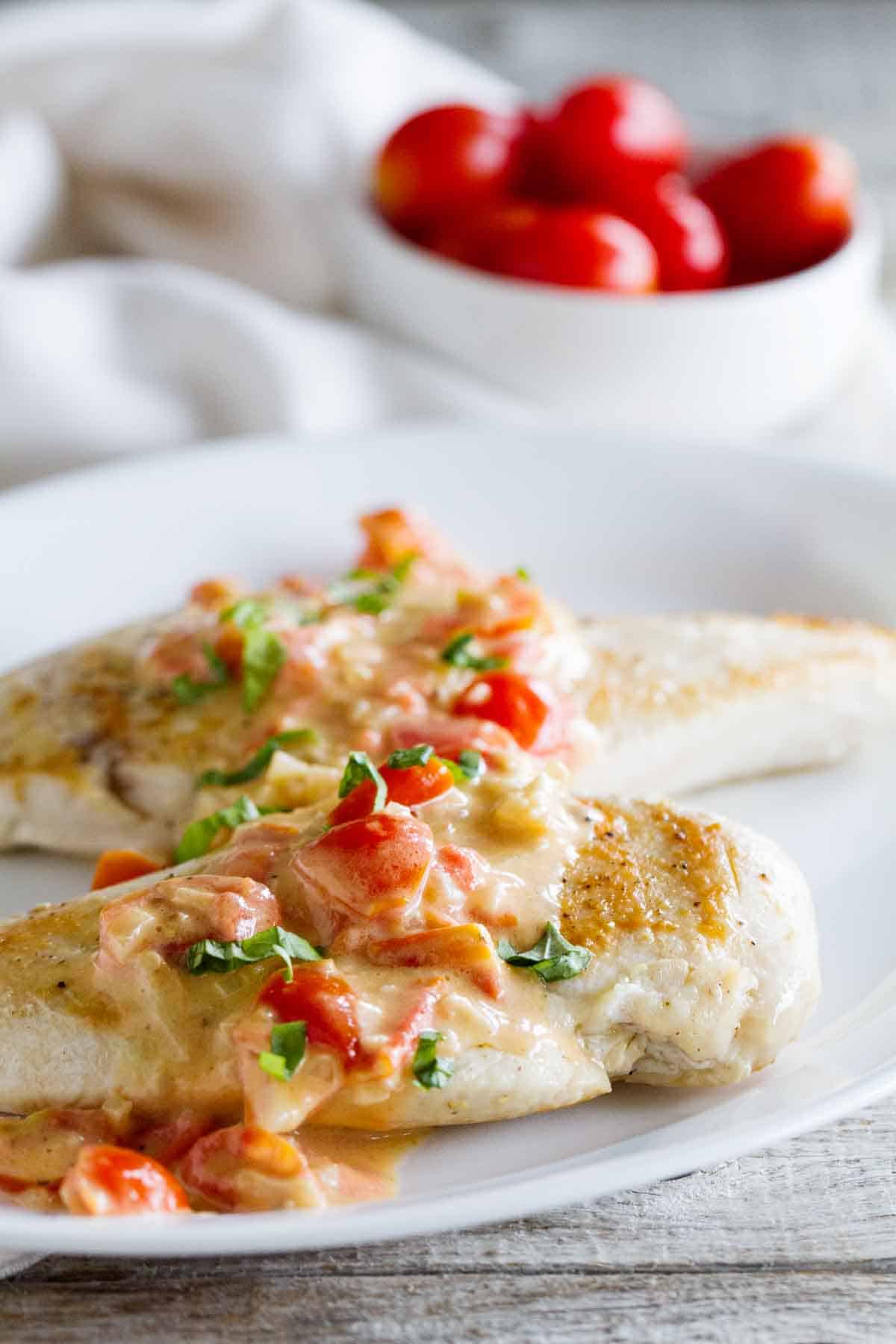 Chicken breasts topped with a cream sauce made with tomatoes, parmesan and basil