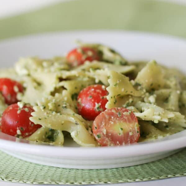 Pasta with Pesto, Feta and Cherry Tomatoes in a white bowl