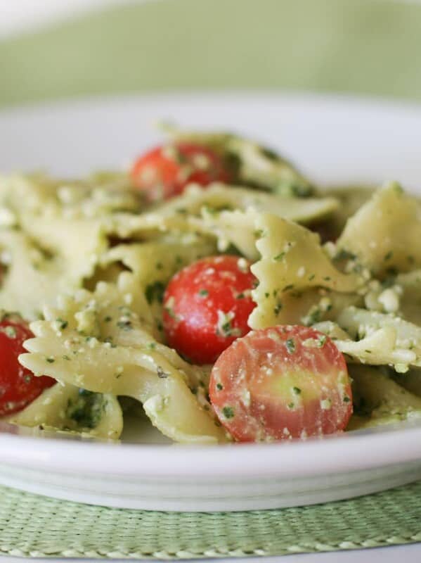 Pasta with Pesto, Feta and Cherry Tomatoes in a white bowl