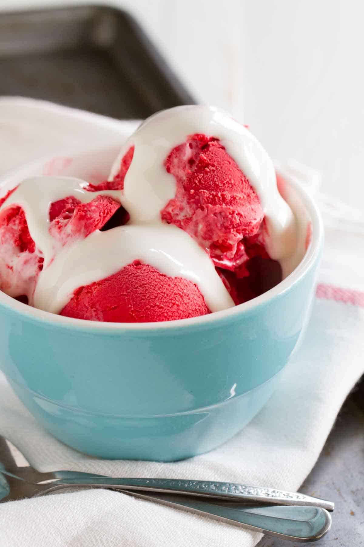 red velvet ice cream in a bowl topped with marshmallow creme