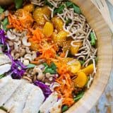 top view of salad with chicken, cashews, mandarin oranges, carrots, chow mein noodles and greens