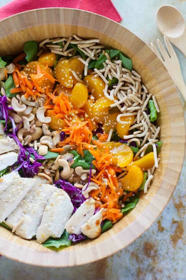 top view of salad with chicken, cashews, mandarin oranges, carrots, chow mein noodles and greens