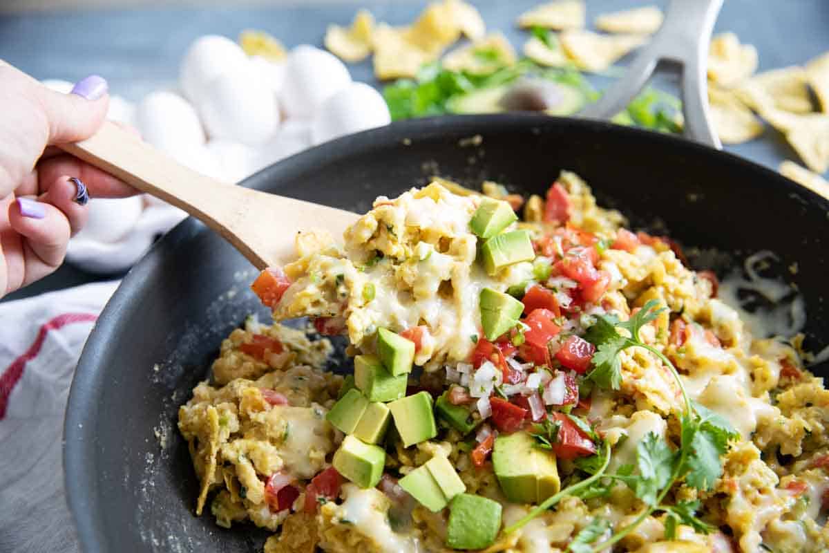 scooping migas from a skillet