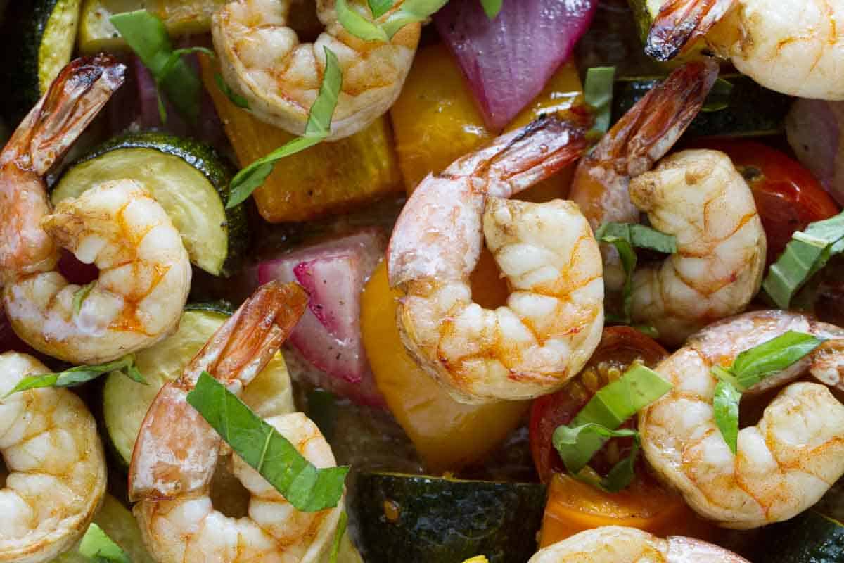 close up of cooked shrimp with chopped vegetables