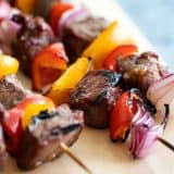 steak kabob with red and yellow peppers and red onion