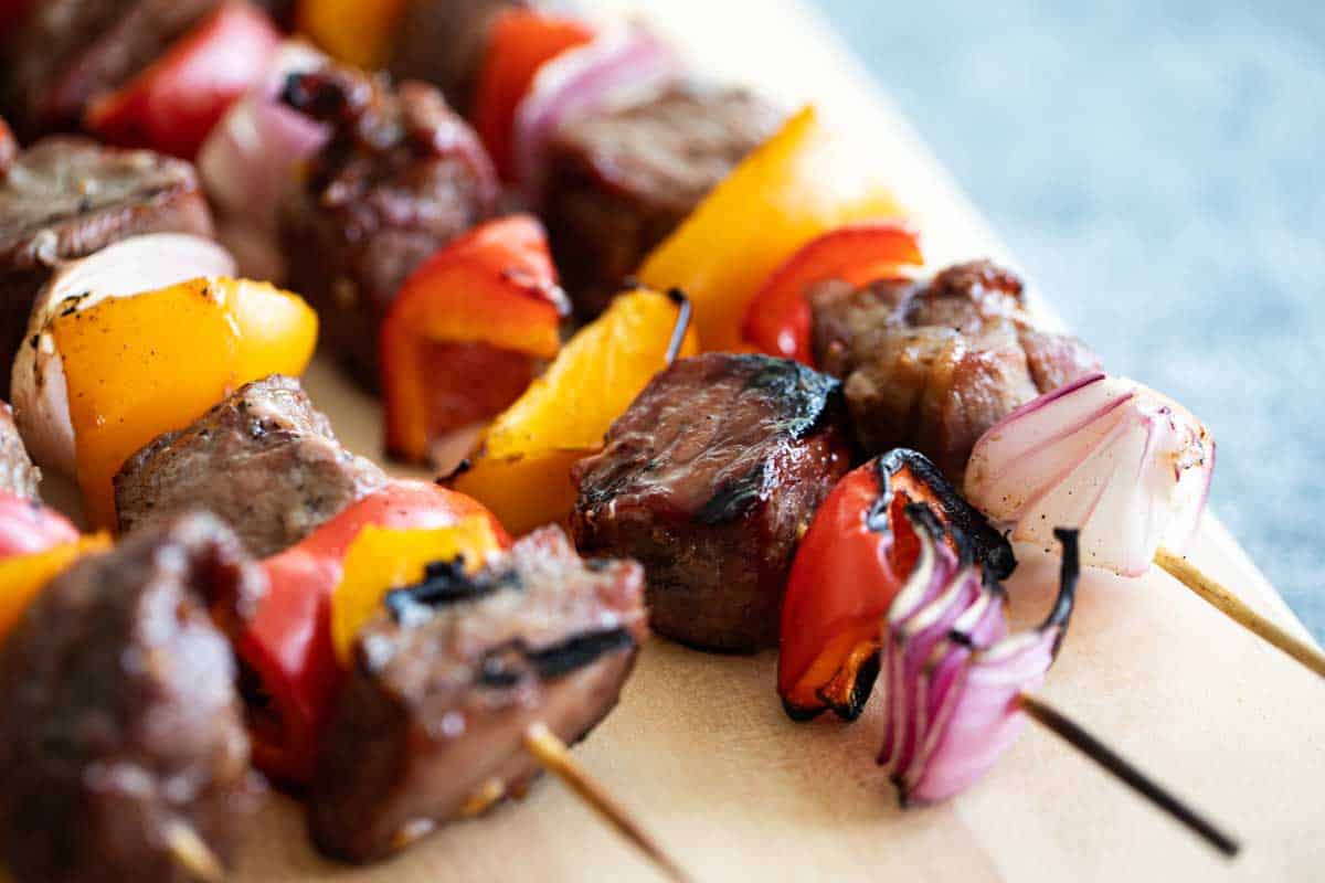 steak kabob with red and yellow peppers and red onion