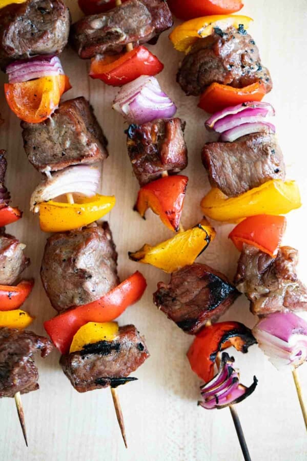 steak, peppers and onions on a skewer, cooked and charred.