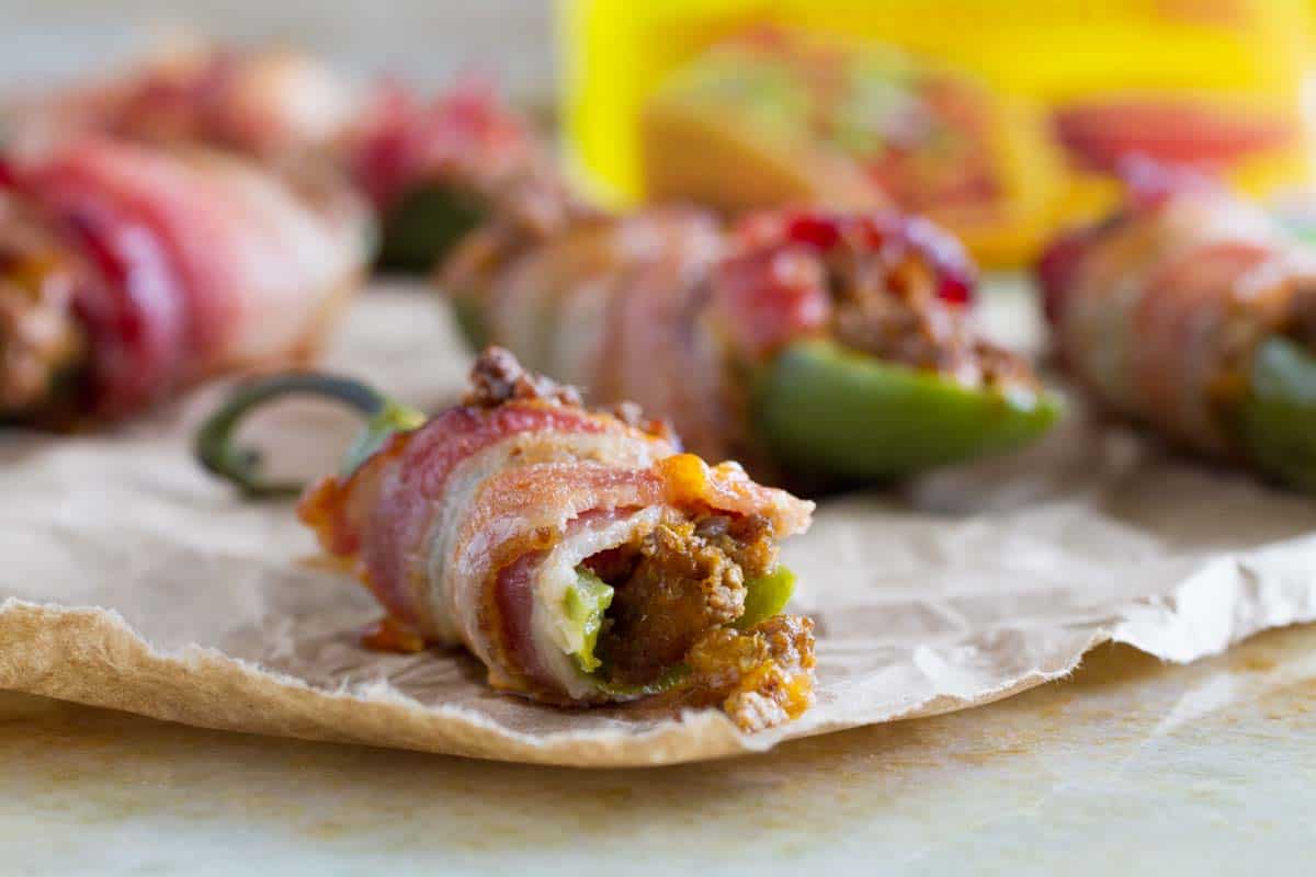 close up of bacon wrapped jalapeno popper with bite taken