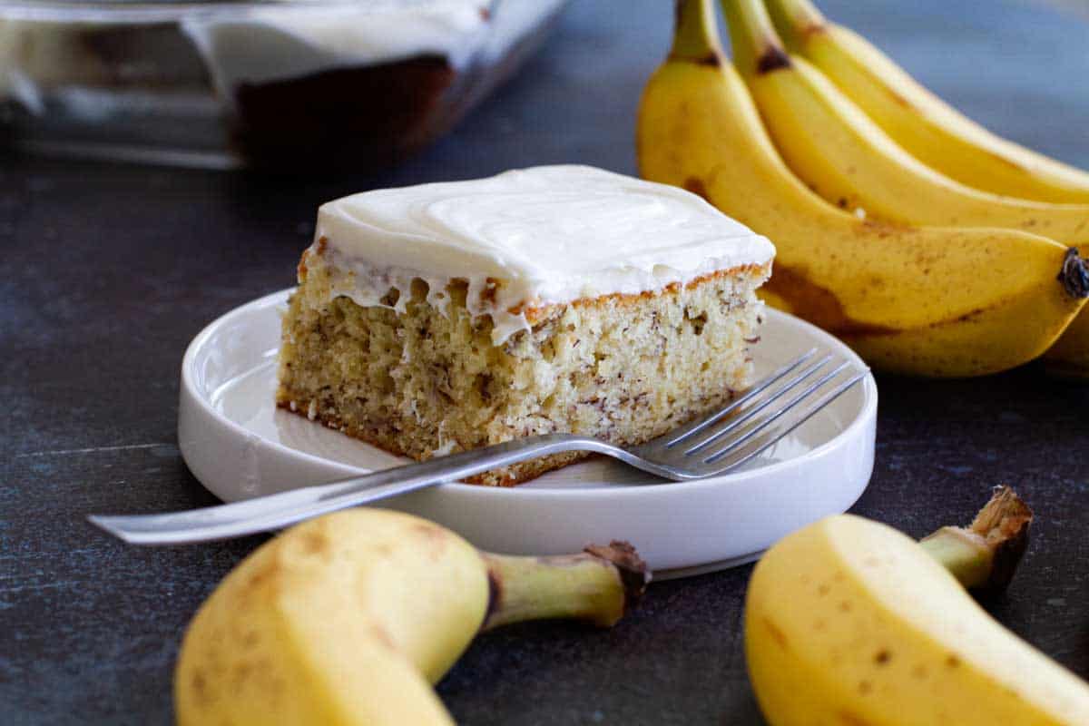 slice of banana cake on a plate with a fork