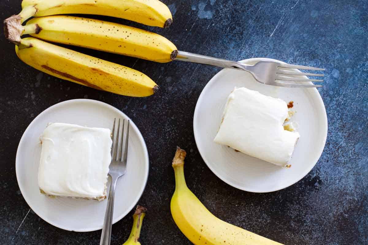 overhead view of banana cake on plates with ripe bananas