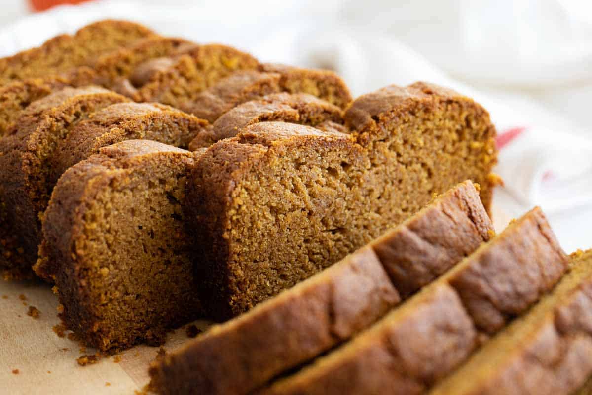 Perfectly spiced and perfectly moist, this Pumpkin Bread Recipe is the one you need for fall baking! It takes only minutes to prep, and don’t be surprised if it disappears just as quickly! sliced loaf of pumpkin bread