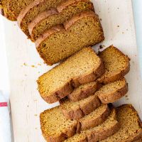 overhead view of sliced pumpkin bread on a cutting board