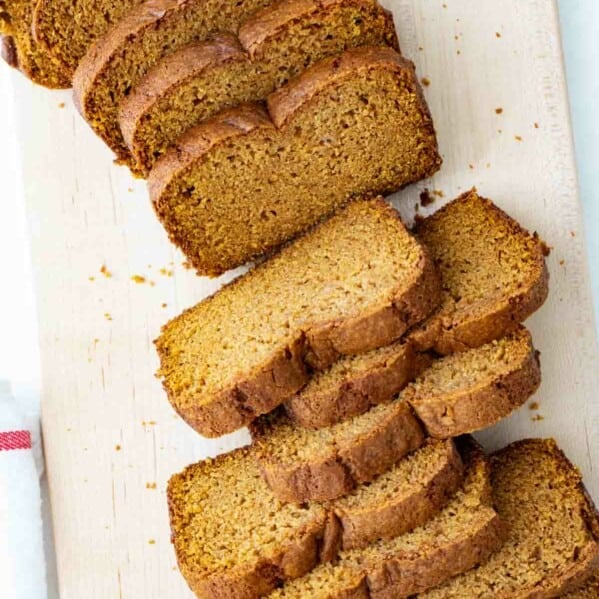 overhead view of sliced pumpkin bread on a cutting board