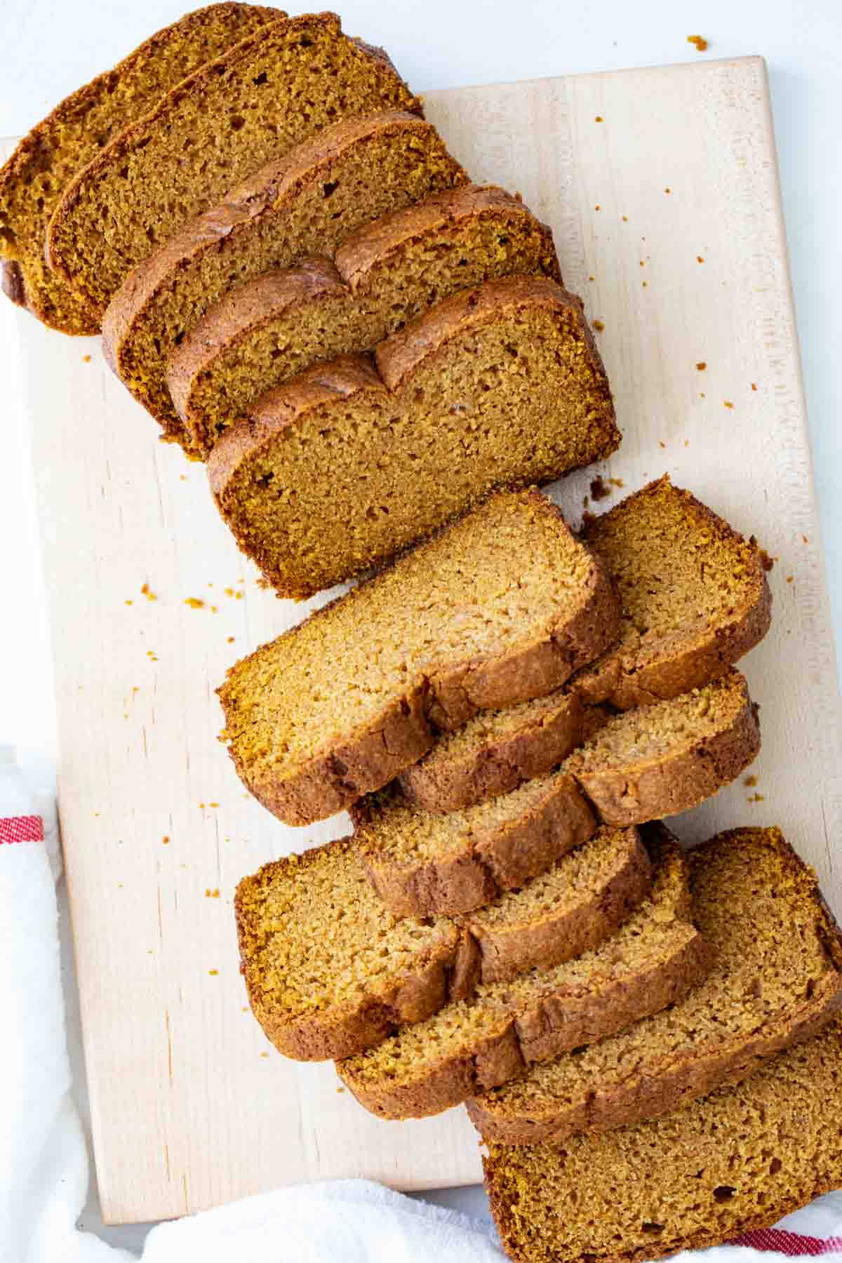 overhead view of sliced pumpkin bread on a cutting board